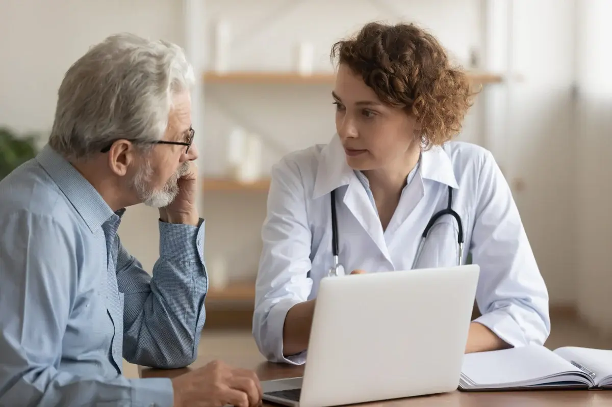 Neurologist discussing concussion assessment and biomarker monitoring with a patient